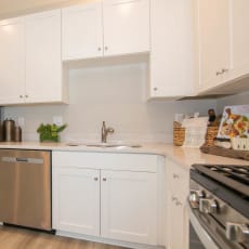 a kitchen with white cabinets and a stainless steel refrigerator at Jackson Run Townhomes, Whitestown