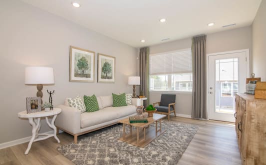 a living room with a couch and a table at Jackson Run Townhomes, Whitestown