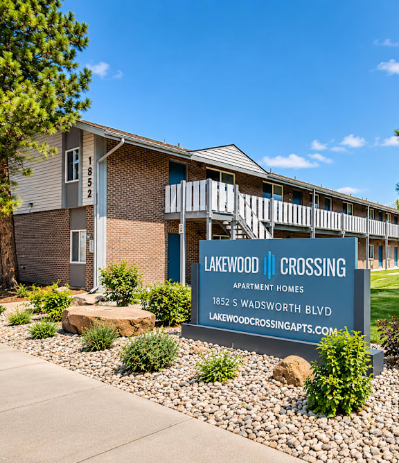 A sign for Lakewood Crossing Apartments is displayed in front of a building.