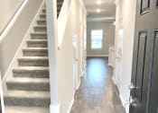 Thumbnail 6 of 60 - B1 (1-car) Entry with starcase facing front door, laminate wood flooring
