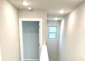 Thumbnail 49 of 60 - C1 (2-car) top of Stairs facing entry door below