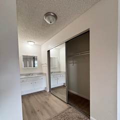 an empty kitchen with a sliding glass door to the laundry room