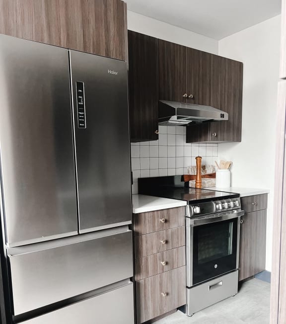 a kitchen with stainless steel appliances and wooden cabinets