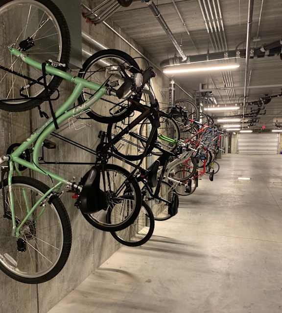 A bike rack with many bikes parked in it.