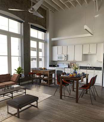 a view of a living room with a kitchen and a dining room at Lofts at Union Alley, Memphis