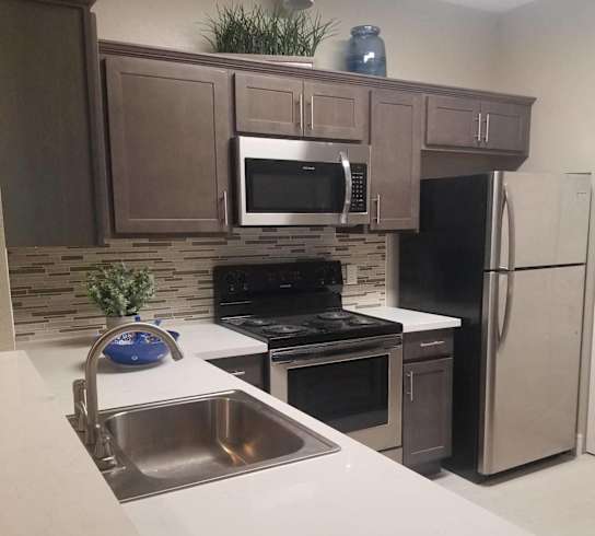 a kitchen with stainless steel appliances and a sink