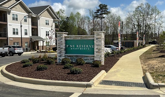 A sign that says Pine Reserve in front of a building.