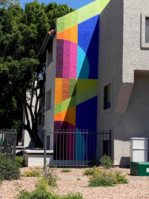 A colorful mural on the side of a building.