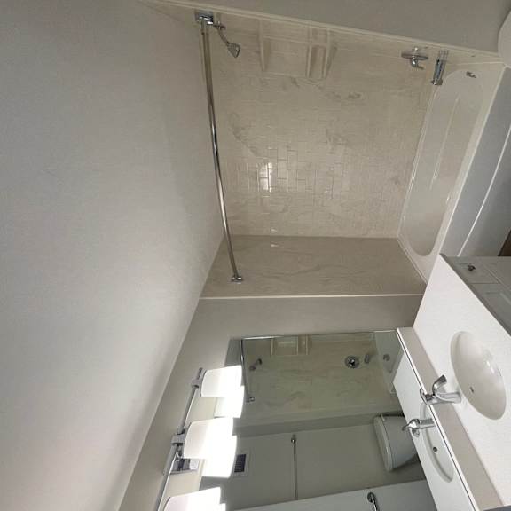a small bathroom with a shower toilet and sink