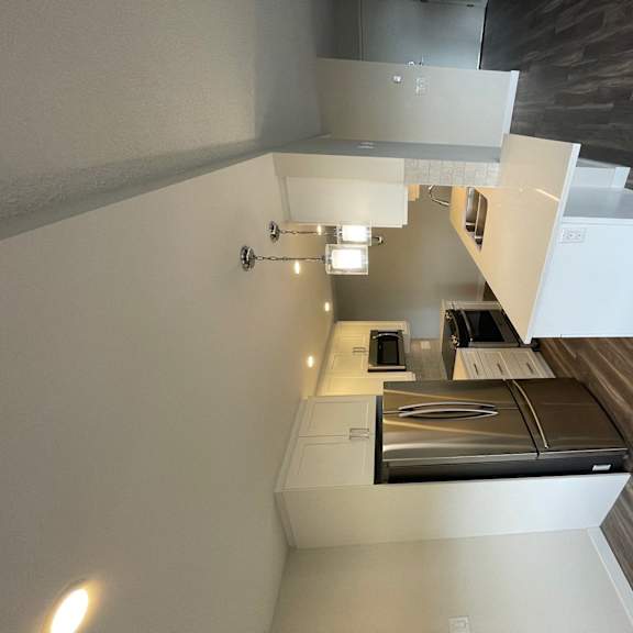 an overhead view of a kitchen with white cabinets and a counter top with an oven