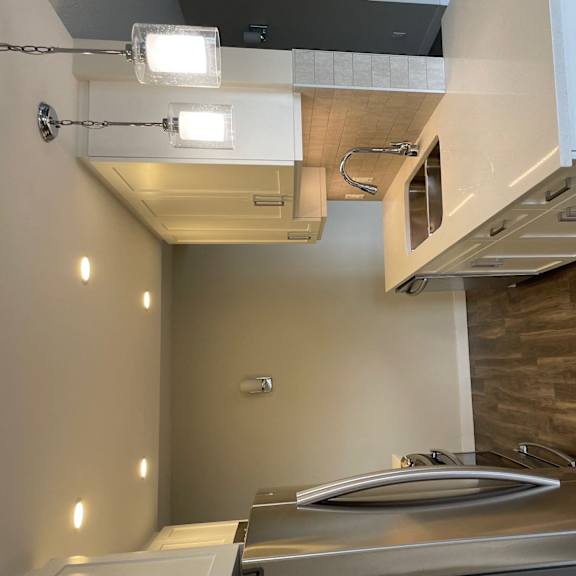 a kitchen with a counter top and a microwave