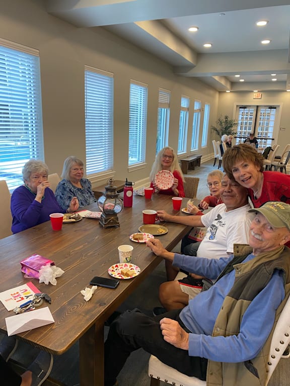 a group of people sitting around a table eating at LIV at Boerne Hills an Active Senior Community 62+, Boerne, TX