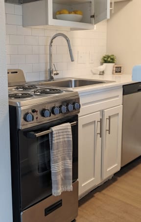 a kitchen with a stove top oven next to a sink