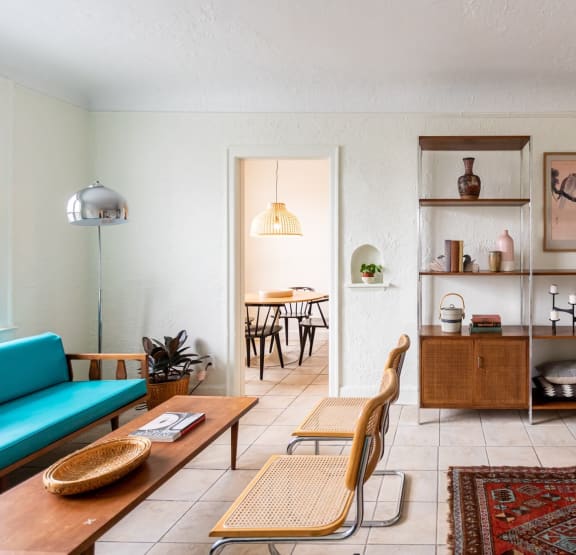 a bedroom with a bed and bookshelves     and a chair