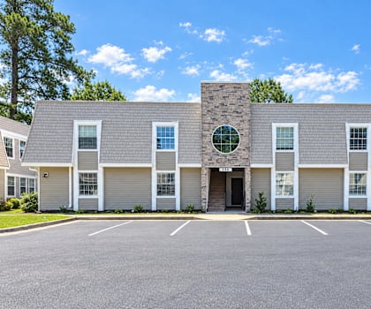 A building with a stone facade and a large circular window in the center.