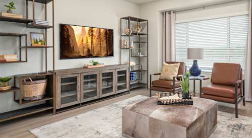 A living room with a large painting on the wall and a wooden cabinet.