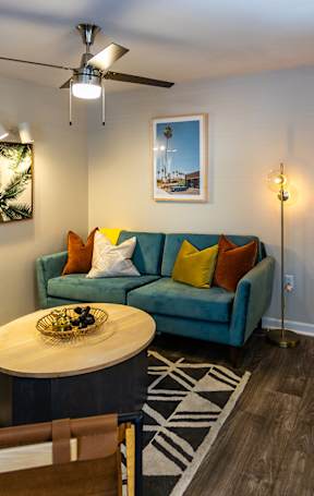A living room with a blue couch and a coffee table.