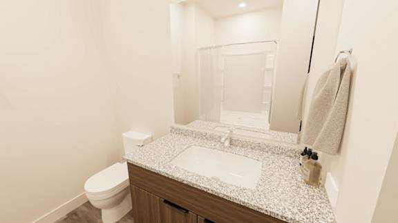 A white toilet sits next to a sink in a bathroom.