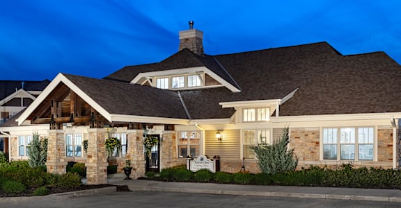 the front of a house at night with the lights on