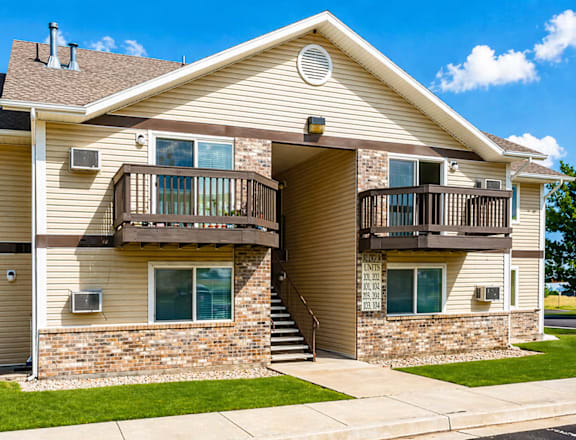 A two-story residential building with a balcony on the second floor.