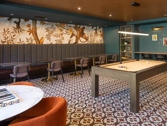 a room with a pool table and a bar