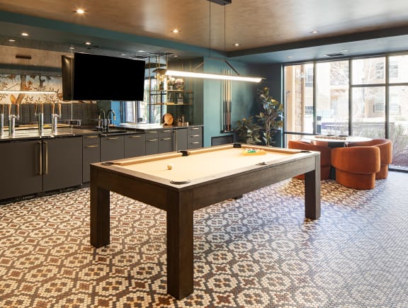 a room with a pool table and a television