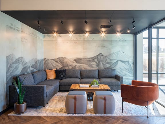 a living room with a mural of a mountain range on the wall