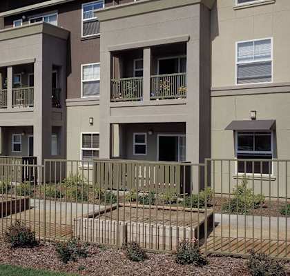 Apartment complex with a green lawn in front.