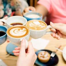 A group of people are sharing cups of coffee.