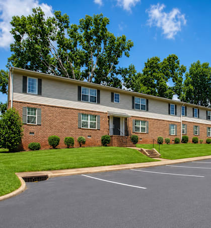 A large building with a parking lot in front of it.