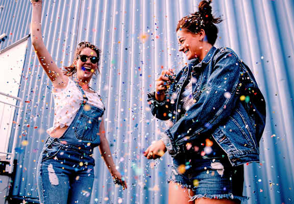 Two women are throwing confetti into the air.at The Dillon, California