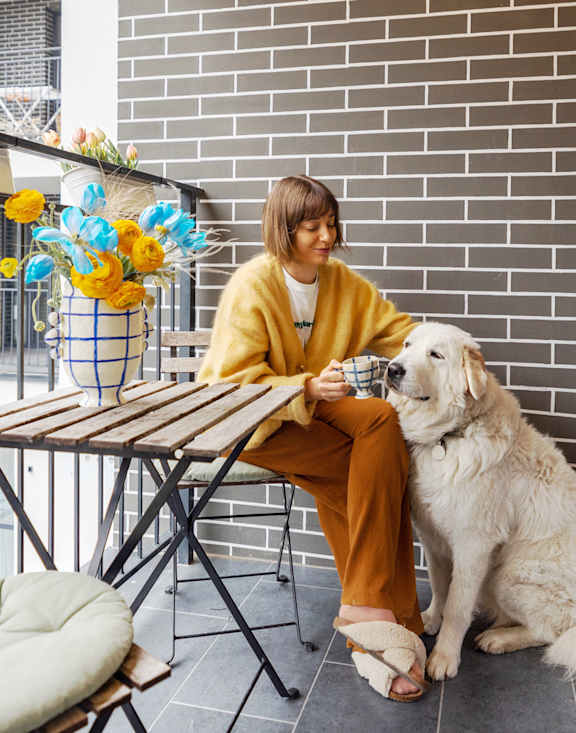 A woman with a white dog at The Maverick Apartments, Kitchener, ON, N2H 0E3
