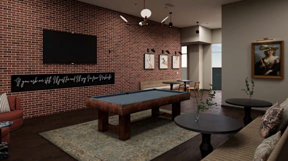 A room with a pool table and a television mounted on the wall.