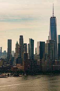 A city skyline with a prominent skyscraper in the center.