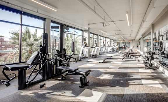 a large fitness room with treadmills and other exercise equipment at Circa Central Avenue in Phoenix, AZ
