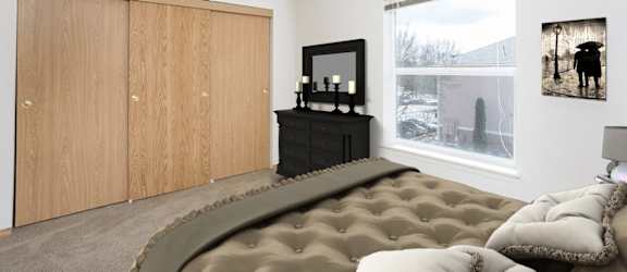 A bedroom with a large bed and a television.