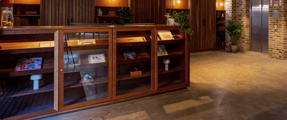 a display case in the lobby of a building with glass doors