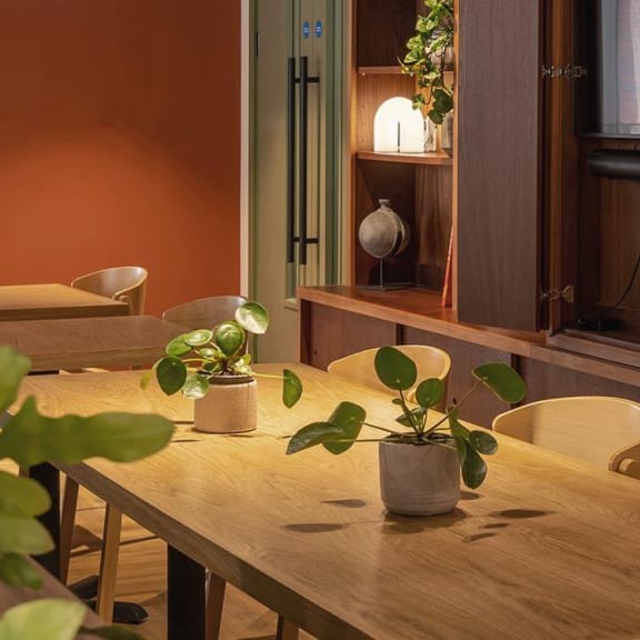 a dining room with a wooden table and chairs
