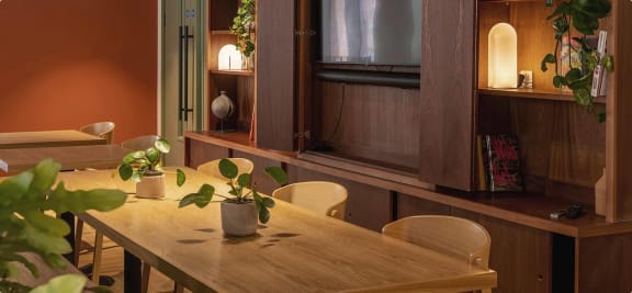 a dining room with a wooden table and chairs