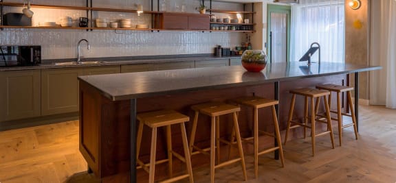 a kitchen with a counter and some bar stools