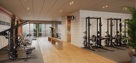 A gym with a variety of equipment including weights and a treadmill.