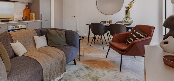a living room with a couch and a table with chairs