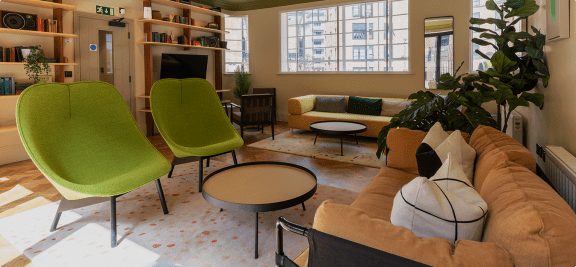 a living room with a couch and chairs and a table