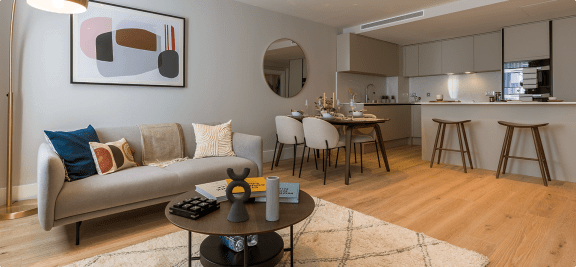 a living room and kitchen with a couch and a table