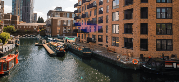 a canal in a city with boats and buildings