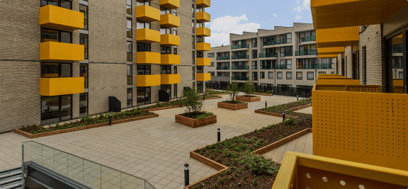 a view of the courtyard of a modern apartment building