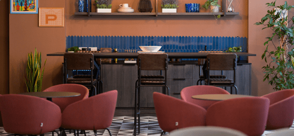 a dining area with chairs and tables and a bar
