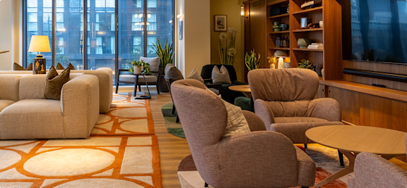 A living room with a large rug and a couch.