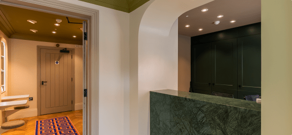 a hallway with a green marble counter top and a door