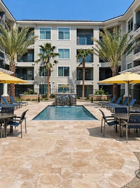 A large courtyard with a pool surrounded by apartment buildings.